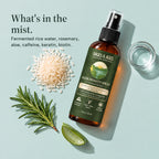 Bottle of fermented rice water and rosemary hair spray laid out with rice, a rosemary sprig, aloe and a glass of water. What's in the mist. Fermented rice water, rosemary, aloe, caffeine, keratin, biotin.