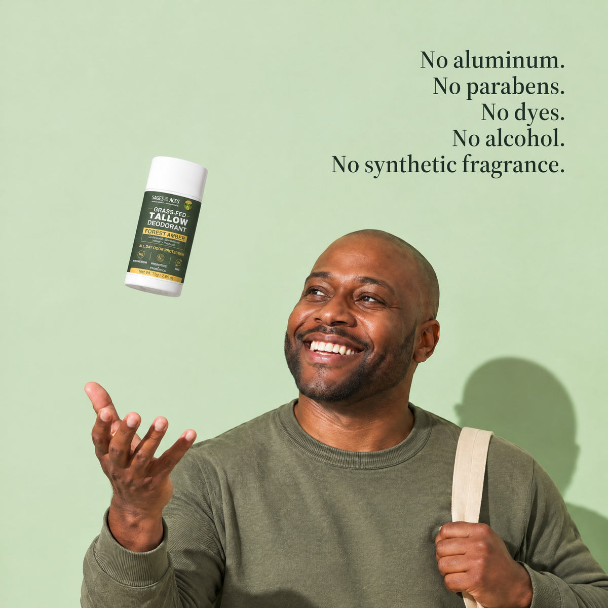 A man smiles as he tosses the grass-fed tallow deodorant stick into the air. No aluminum. No parabens. No dyes. No alcohol. No synthetic fragrance.