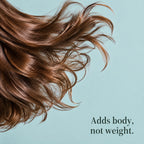 Long brown hair sweeping across a pale blue background. Adds body, not weight.