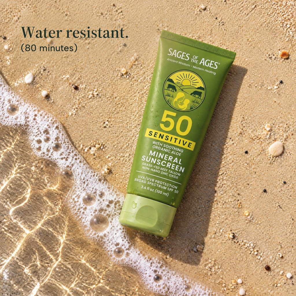 Tube of SPF 50 mineral sunscreen lotion lying on wet sand at the edge of a wave. Water resistant. 80 minutes.