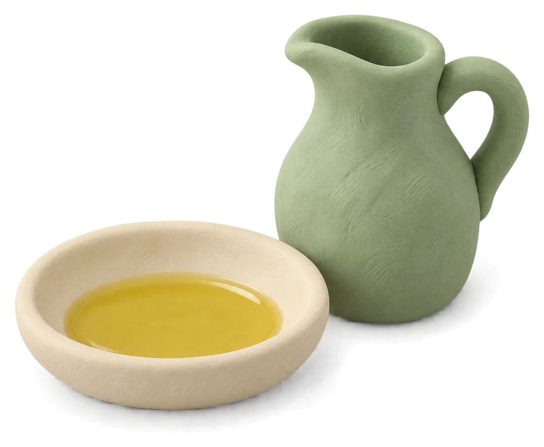A green clay jug beside a shallow dish of golden oil