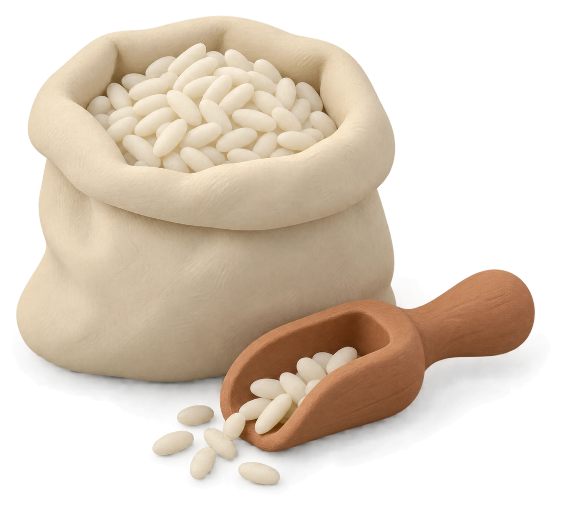 An open clay sack of white rice with a wooden scoop and a few spilled grains